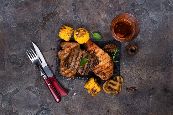 Grilled steak and crispy pork belly with sides and salsas from El Carnitas foodtruck